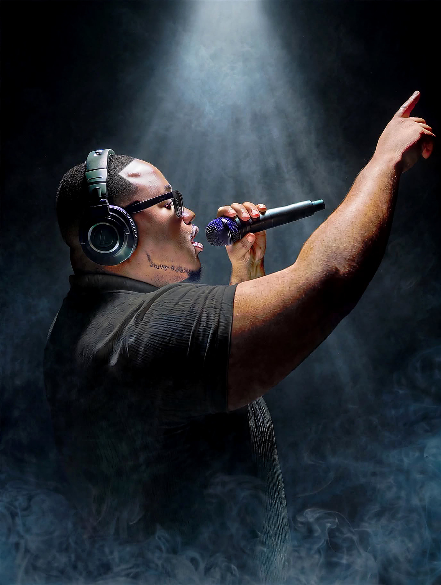 DJ Dough Boyy performing with headphones and a microphone