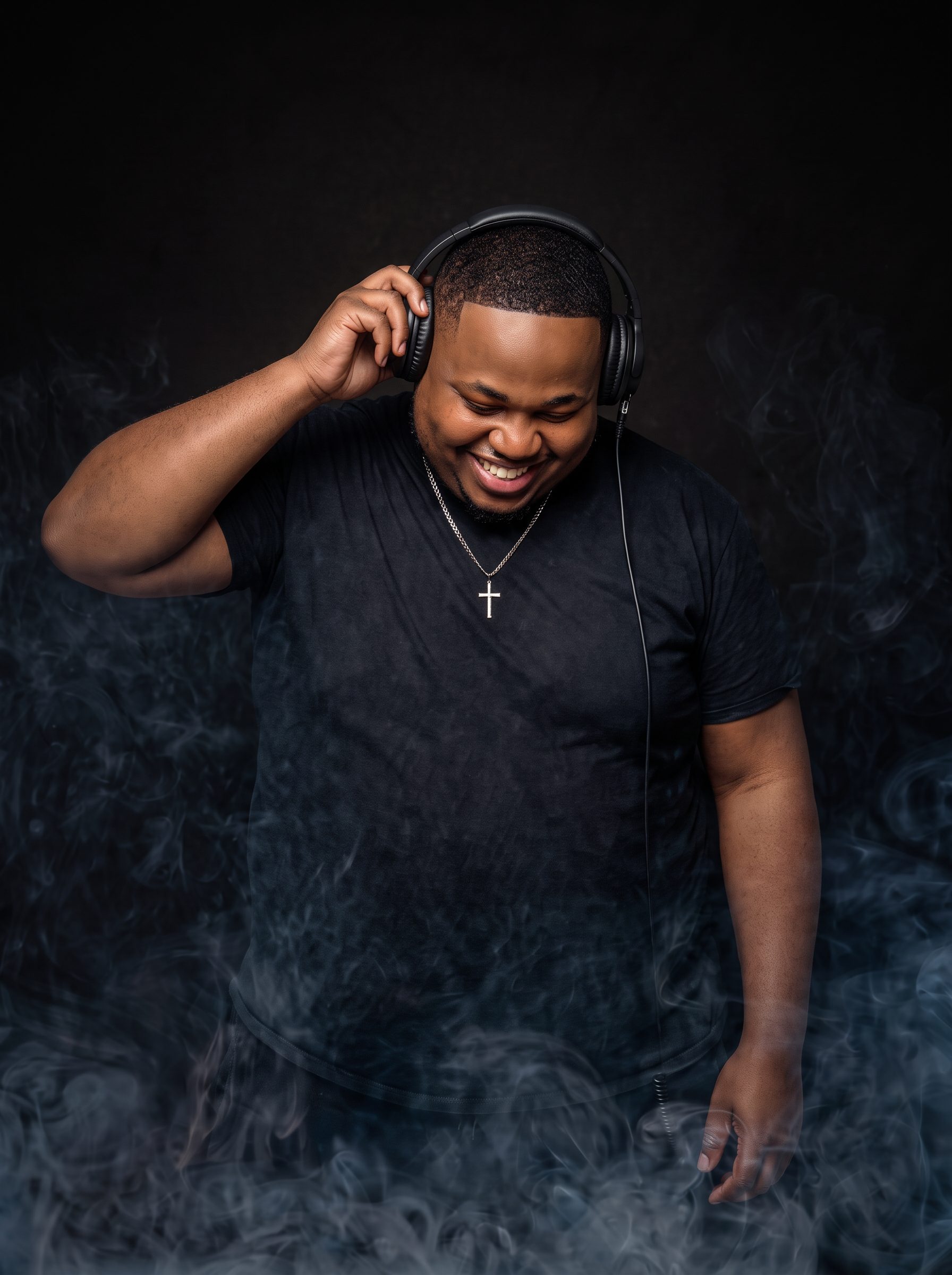 DJ Dough Boyy smiling with headphones